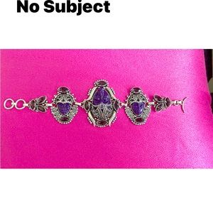 This is a Sterling bracelet with amethyst stone.